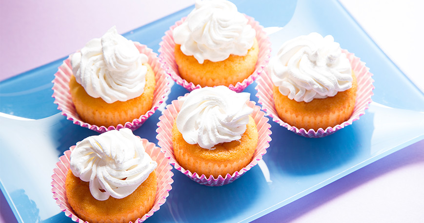 Sponge cake cupcakes with whipped cream