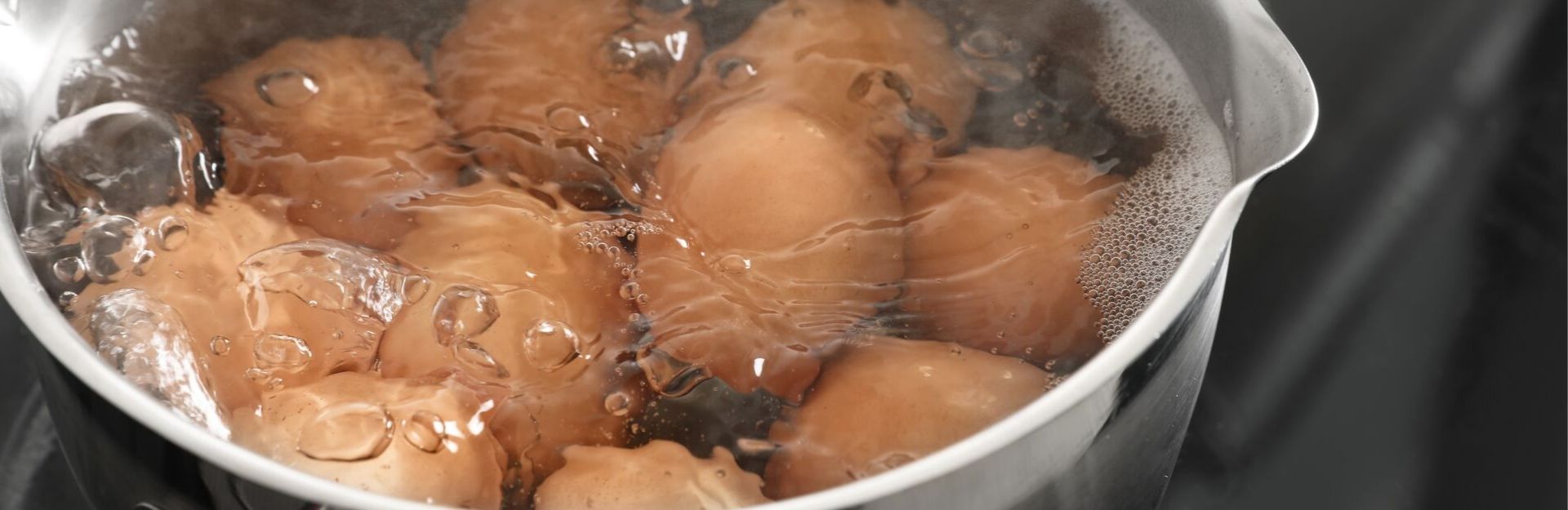 Eggs are being boiled in a pot.