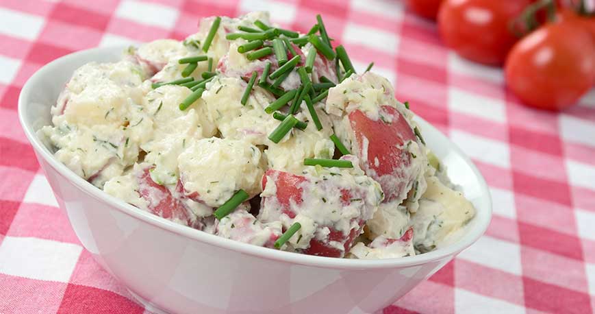 a red potato salad on a picnic blanket