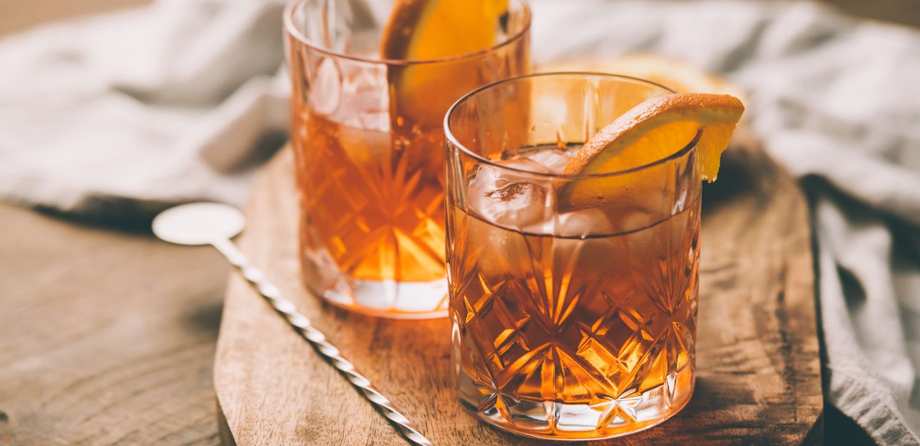 Two bourbon cocktails on a table.